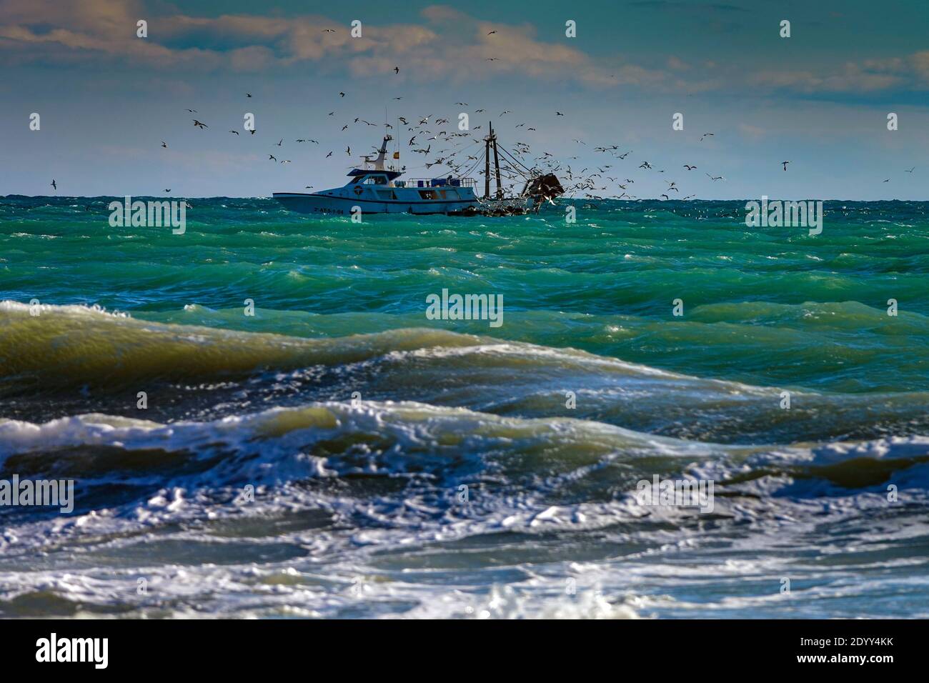 Fishing boat with waves and seagulls, an analogy for Brexit, Calpe, Spain Stock Photo