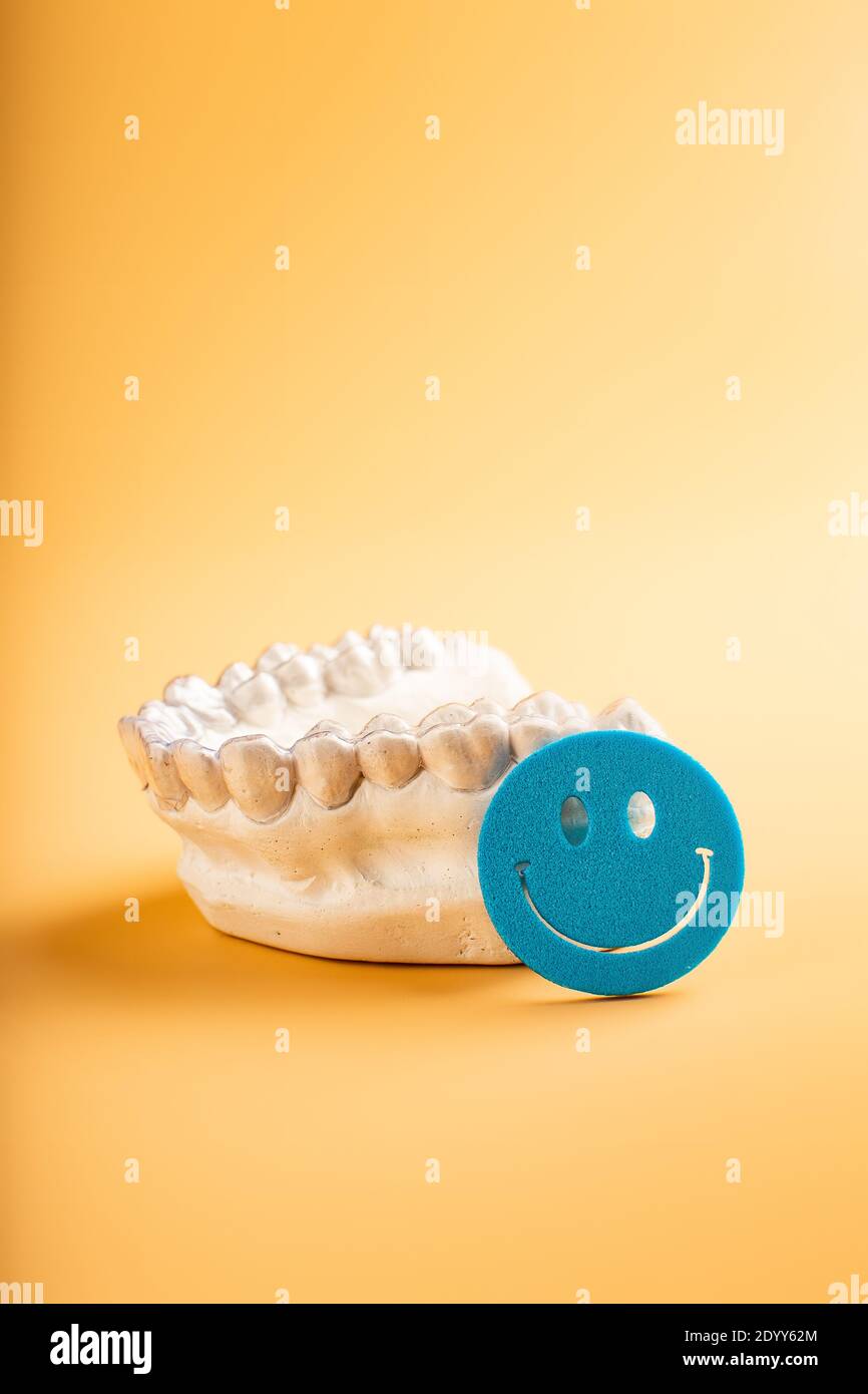 Closeup individual tooth tray Orthodontic dental theme. In hand Invisible braces Stock Photo