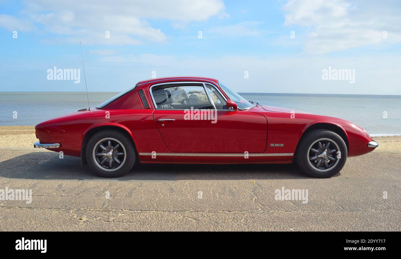 Classic Red Lotus  Elan +2  Motor Car Parked on Seafront Promenade. Stock Photo