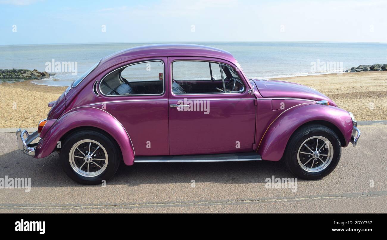 Classic Purple  VW Beetle Motor Car Parked on Seafront Promenade. Stock Photo