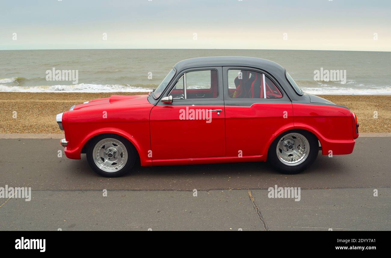 Classic Red & Black Riley 1.5 motor car parked on seafront promenade. Stock Photo