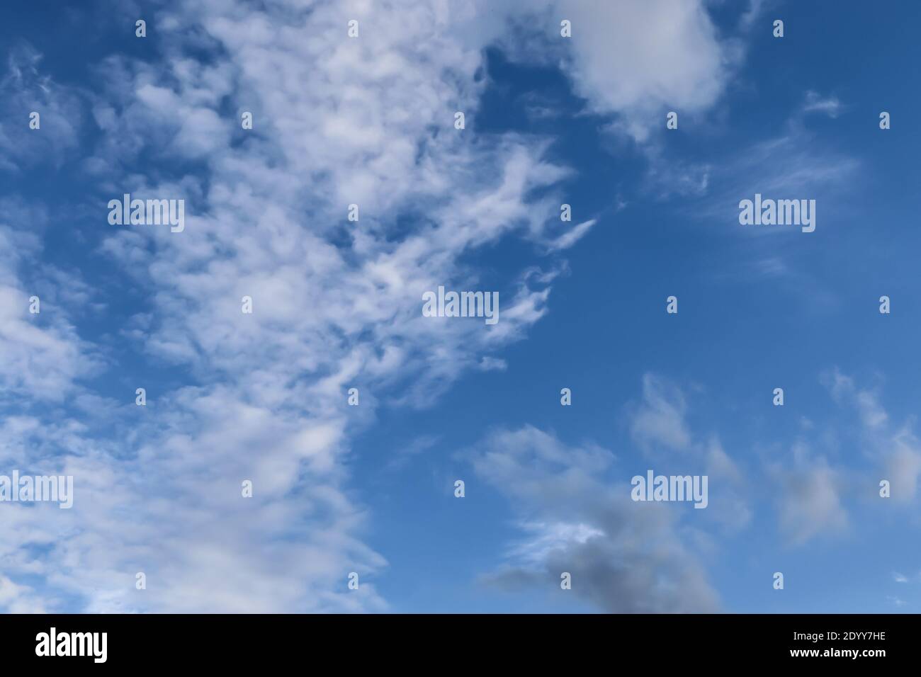 Stunning cirrus cloud formation panorama in a deep blue summer sky seen ...