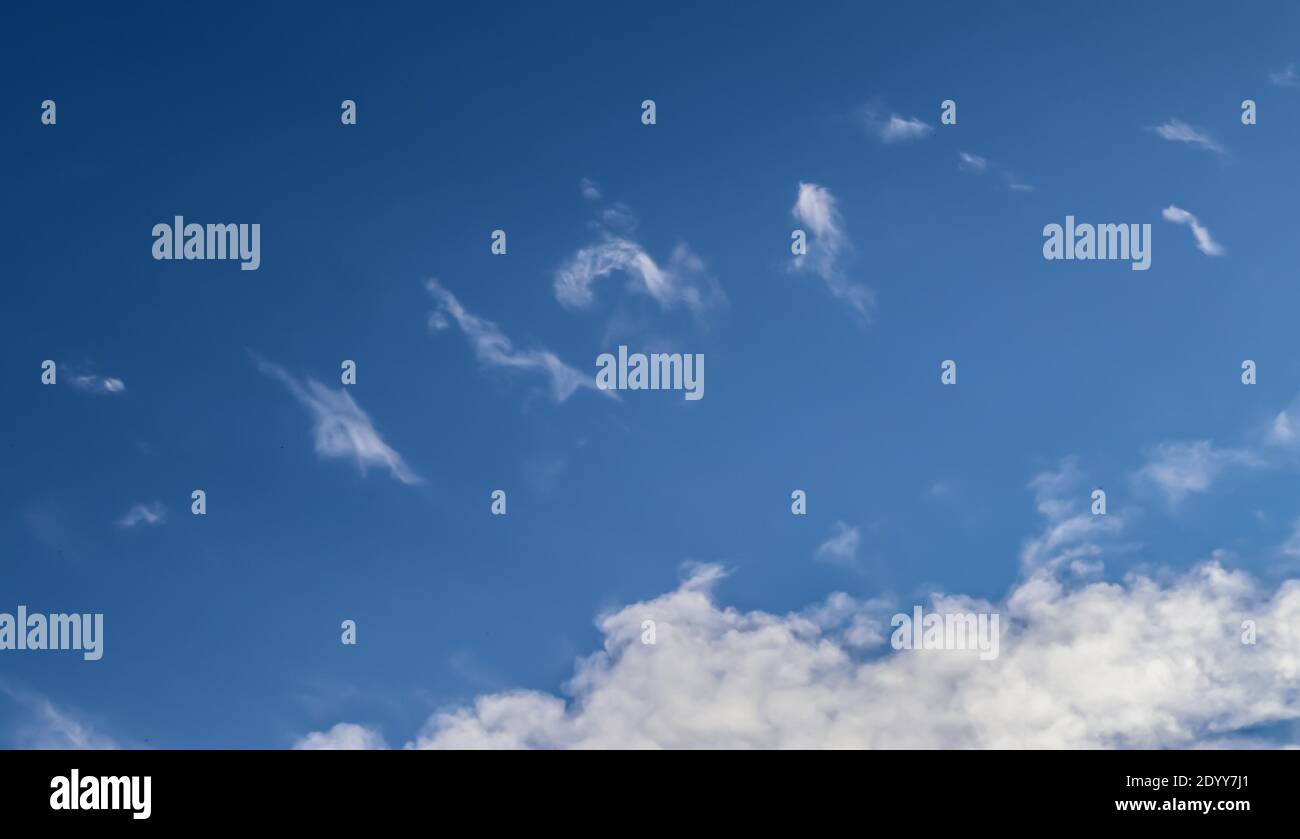 Stunning cirrus cloud formation panorama in a deep blue summer sky seen ...