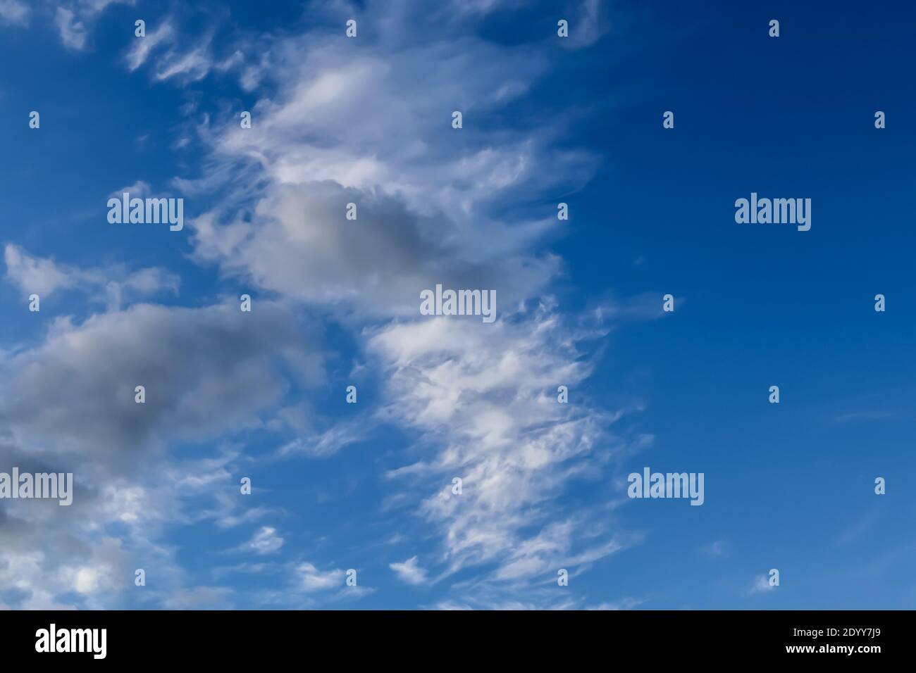 Stunning cirrus cloud formation panorama in a deep blue summer sky seen ...