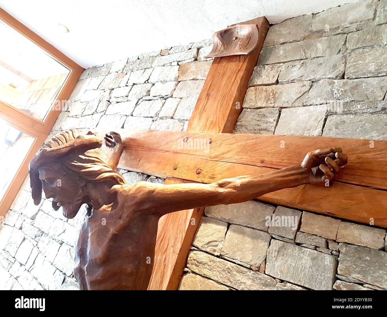 mountain wood that became a sculpture of jesus christ crucified for us, spontaneous religiosity of the people Stock Photo