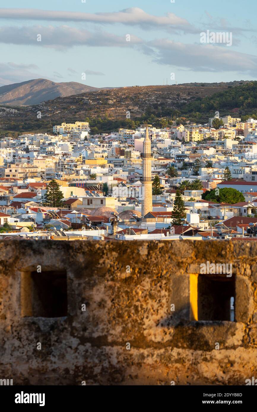 Cityscape view of Rethymno over the fortified walls of Fortezza Castle, showing the minaret of Neratze Mosque, Crete, Greece Stock Photo
