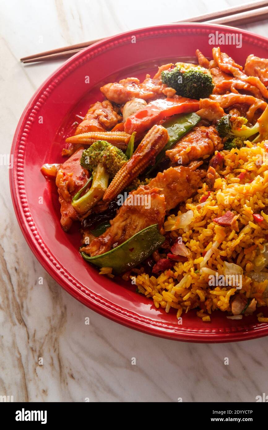 Szechuan stir fried chicken with chinese vegetables and pork fried rice Stock Photo