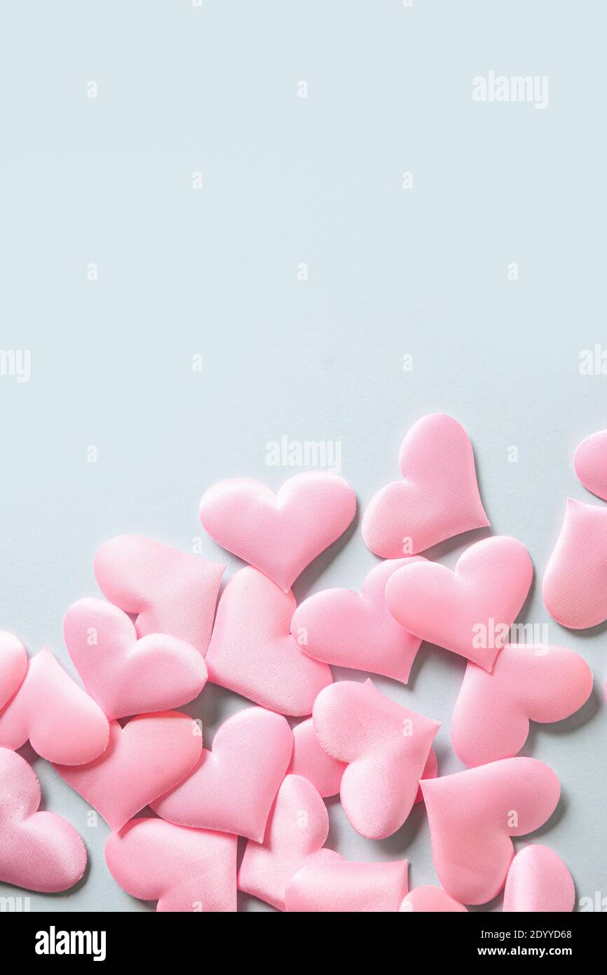 Romantic pink hearts on blue background. Valentine's day greeting card