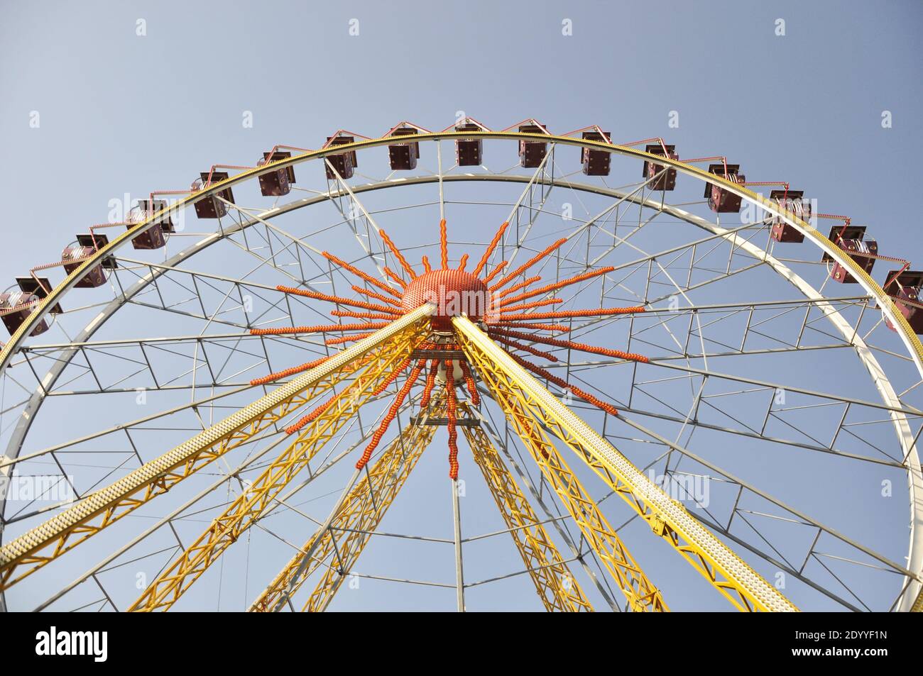 Yellow ferris wheel in an amusement park.  Stock Photo