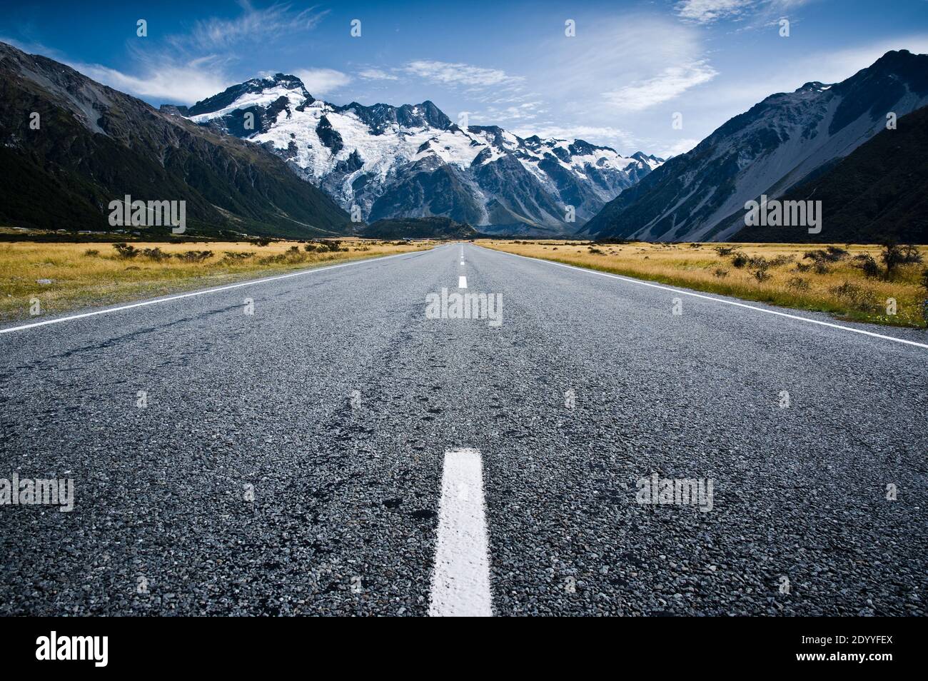 A low wide angle perspective of the road leading into Mt Cook National Park in New Zealand. Stock Photo