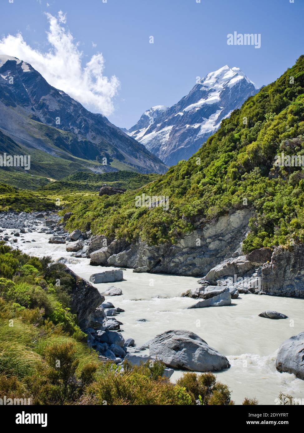 A landscape view of the glacial river leading along the Hooker valley in Mt Cook National Park, New Zealand, on a sunny summer day. Stock Photo