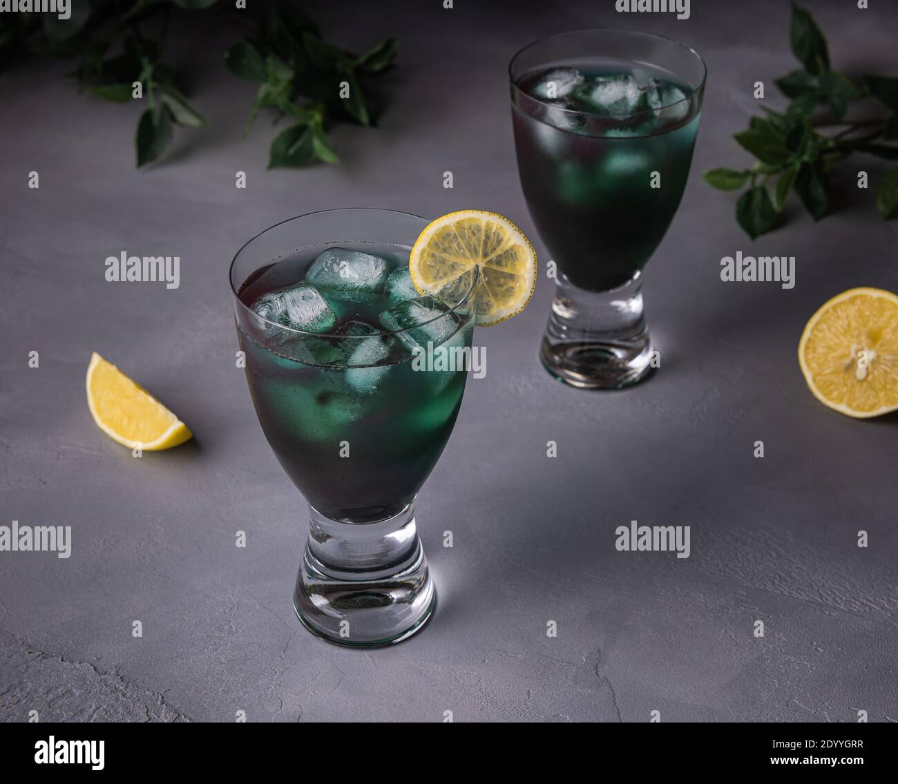 Chlorella or spirulina algae green mocktail in glasses with lemon juice