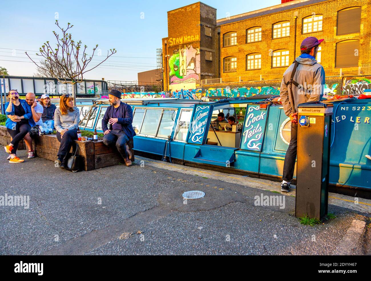 Alfred Le Roy Cocktail barge and people drinking outside CRATE Brewery & Pizzeria on the River Lee Navigation Canal, Hackney Wick, London, UK Stock Photo