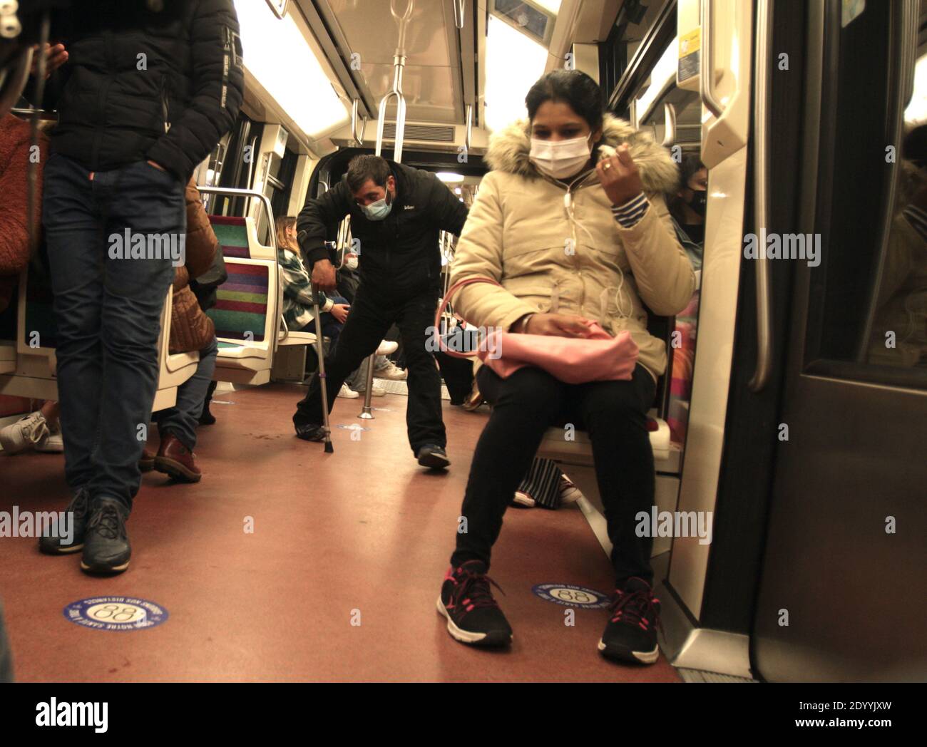 Paris, France. 28th Dec, 2020. A man wearing protective face mask against Covid-19 asks commuters for help on the line 1 subway Paris amid the coronavirus pandemic on December 28, 2020 in Paris, France. According the latest report of the French National Authority for Health (HAS) 175 people died in hospital, and 8,822 new cases of Covid-19 infection, strict measures are still in place as curfew from 8:00 p.m. to 6:00 a.m. was put in place in all territory French. (Photo by Paulo Amorim/Sipa USA) Credit: Sipa USA/Alamy Live News Stock Photo