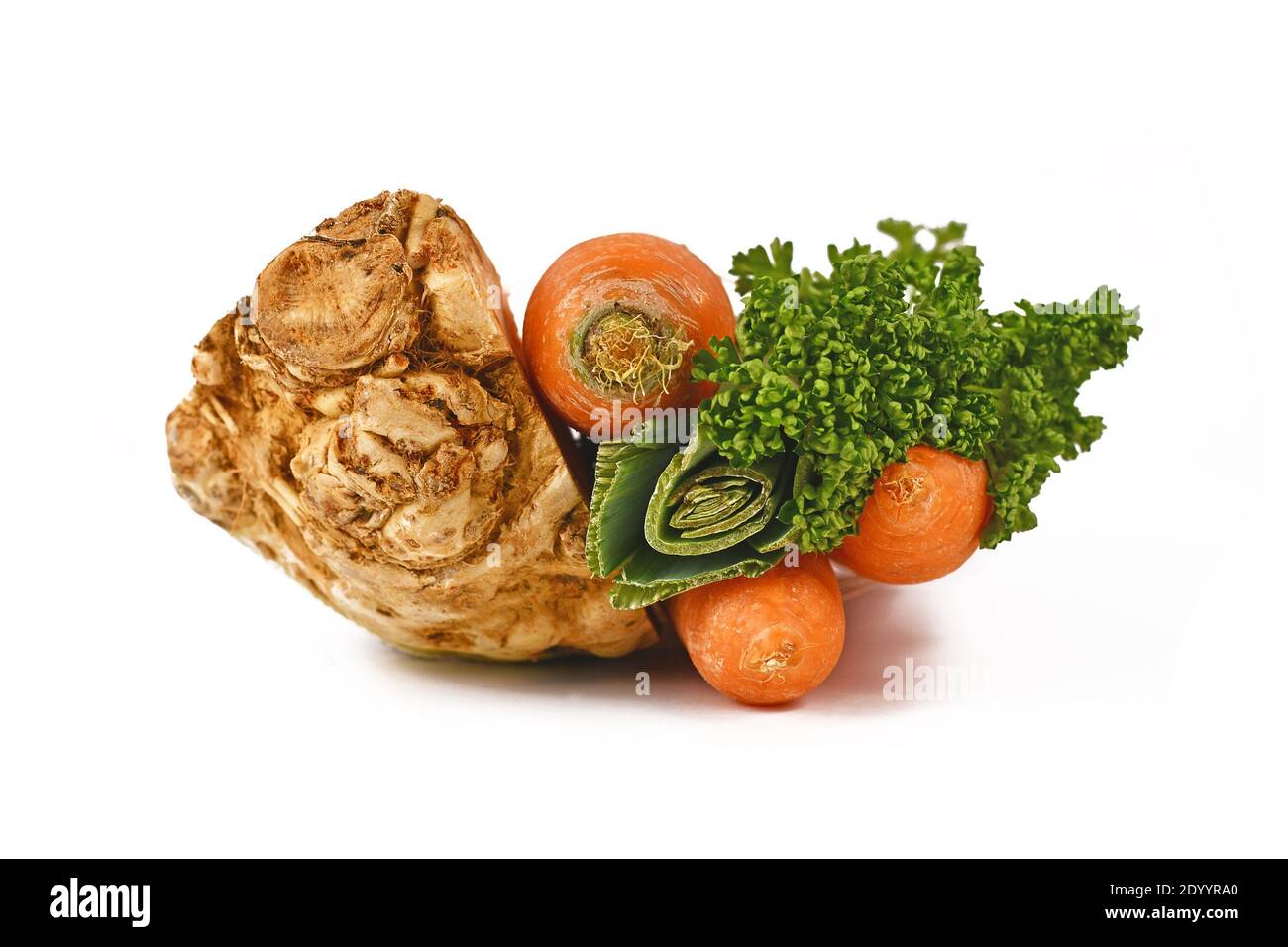 Bunch of soup vegetables containing carrots, leeks, parsley and celery root isolated on white background. Traditionally sold in bundles at German supe Stock Photo