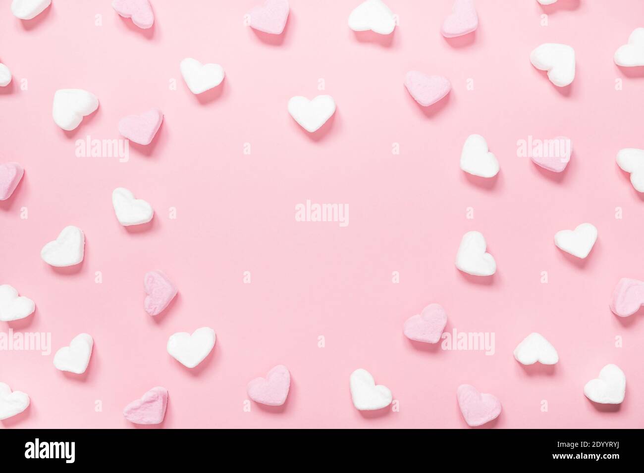 Pink heart-shaped marshmallows in with pink background Stock Photo