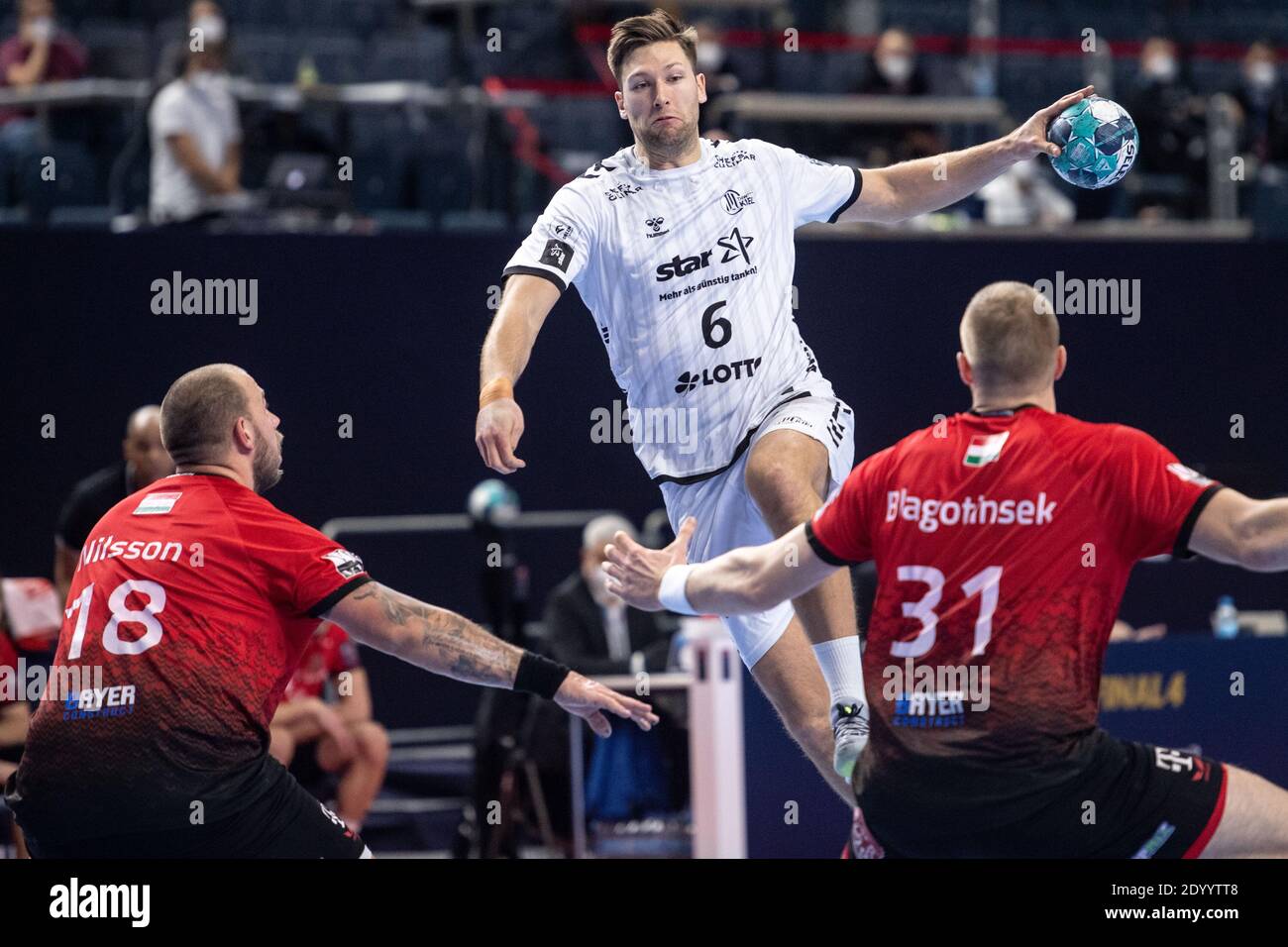 Cologne, Germany. 28th Dec, 2020. Handball: Champions League, THW Kiel -  Telekom Veszprem, final round, final four, semi-final. Veszprem's Andreas  Nilsson (l) and Blaz Blagotinsek (r) try to prevent Kiel's Harald Reinkind