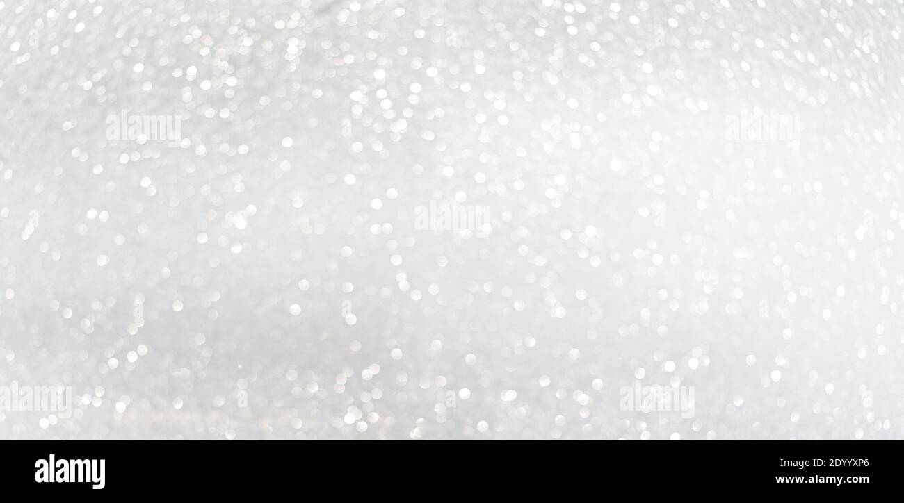 Defocused shining silver bokeh texture. Holiday background Stock Photo