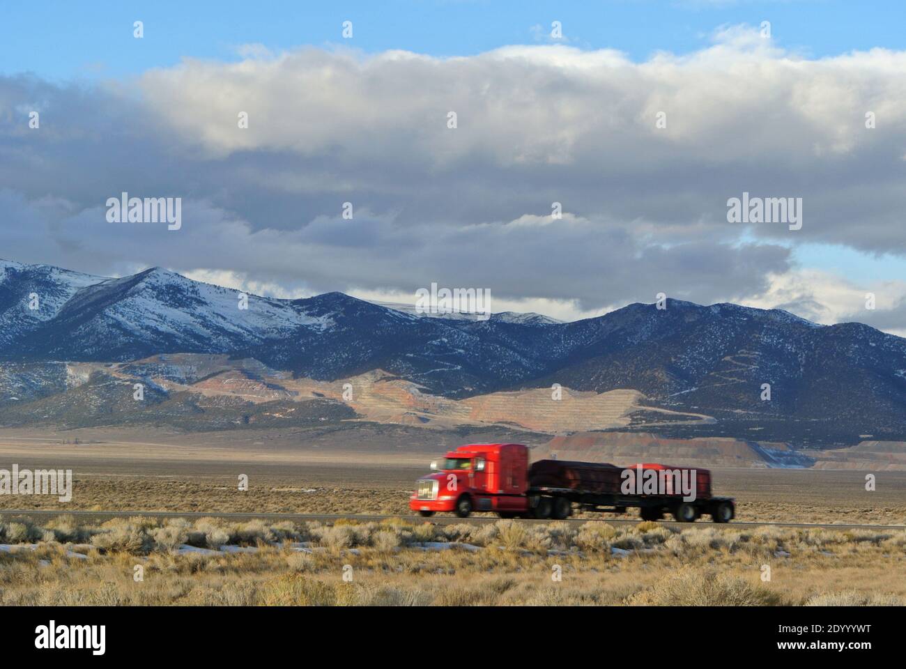 tractor trailer on hwy 80 in  snow capped mountain norther nevada high desert landscape  in early winter 2020 Stock Photo