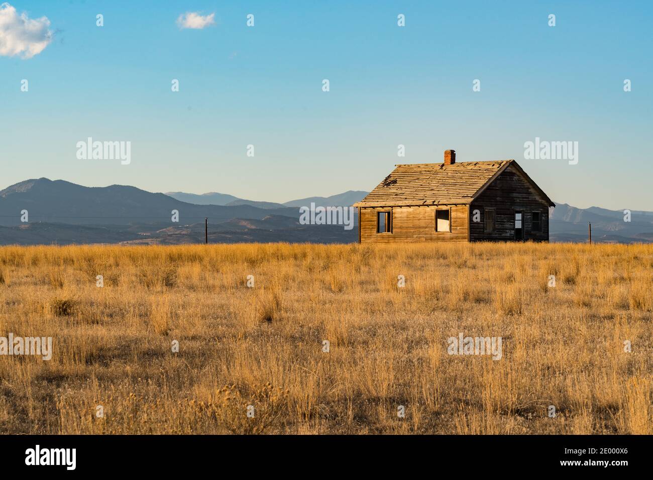Abandoned old farm house near the Rocky Mountains of Colorado at sunset Stock Photo