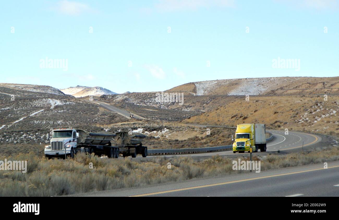 tractor trailer on hwy 80 in  snow capped mountain norther nevada high desert landscape  in early winter 2020 Stock Photo