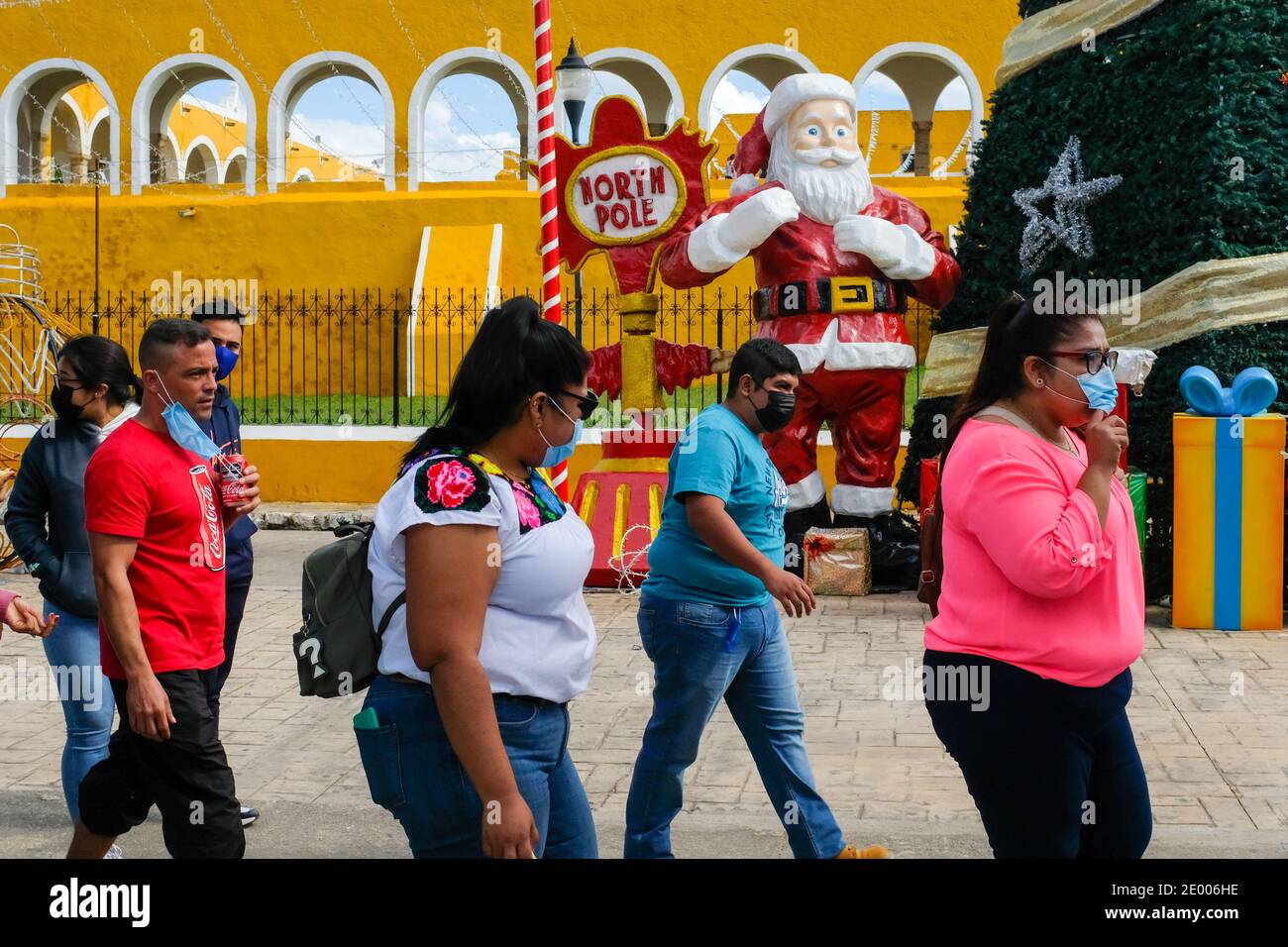 Mexican tourists in front of Convento de San Antonio de Padua, Izamal, Yucatan , Mexico during Christmas time. Covid 19 Pandemic Stock Photo