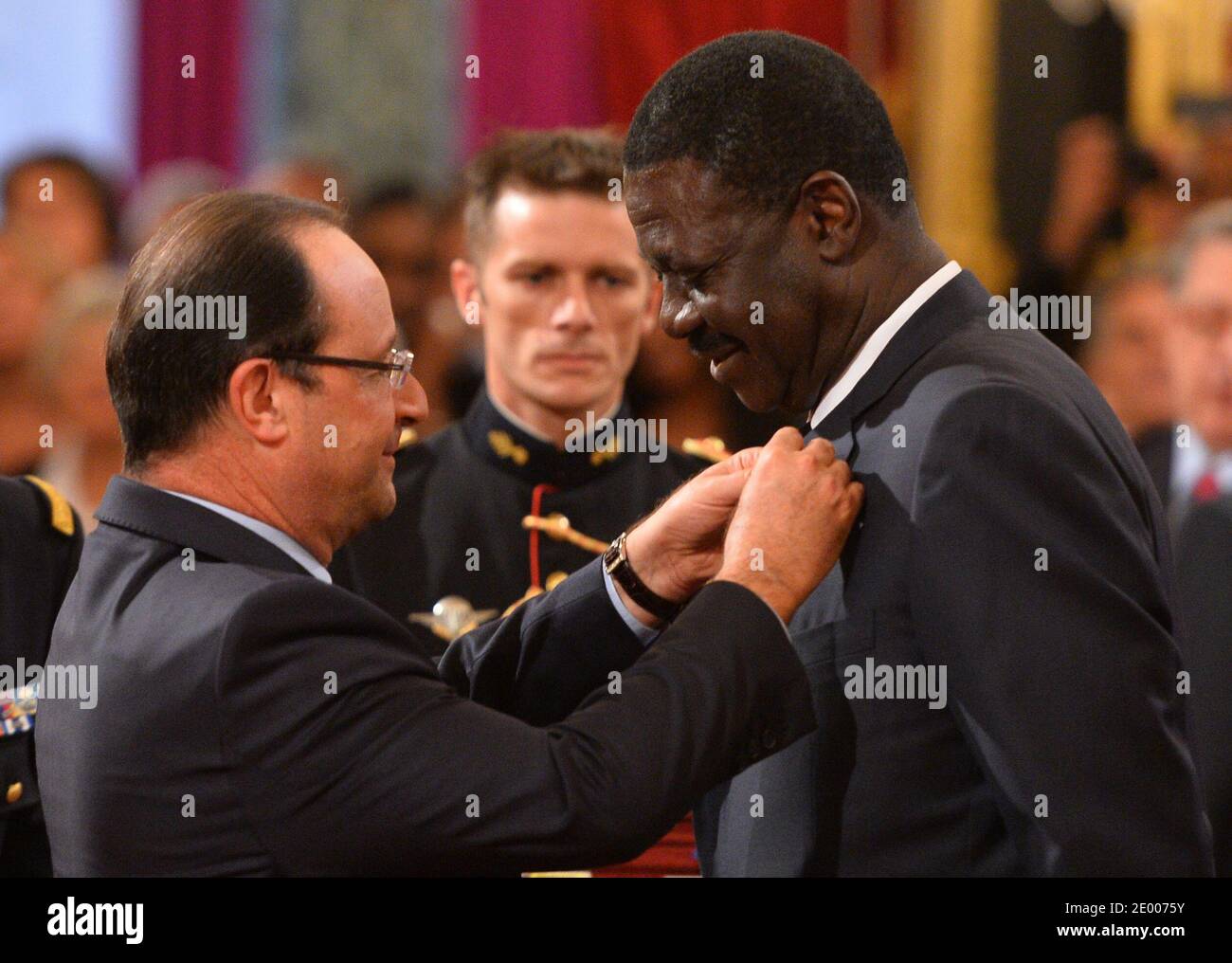 French President Francois Hollande (L) awards the Legion of Honor and National Order of Merit insignia to former Olympique de Marseille football club president Pape Diouf (R) during a ceremony to award French sports personalities at the Elysee Palace in Paris, France on October 9, 2013. Photo by Christian Liewig/ABACAPRESS.COM Stock Photo