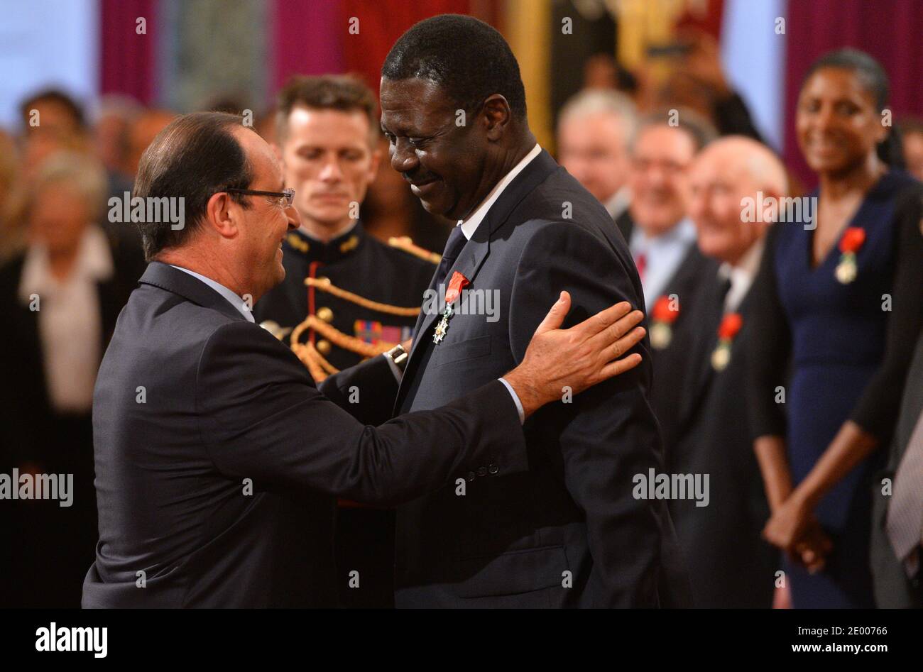 French President Francois Hollande (L) awards the Legion of Honor and National Order of Merit insignia to former Olympique de Marseille football club president Pape Diouf (R) during a ceremony to award French sports personalities at the Elysee Palace in Paris, France on October 9, 2013. Photo by Christian Liewig/ABACAPRESS.COM Stock Photo