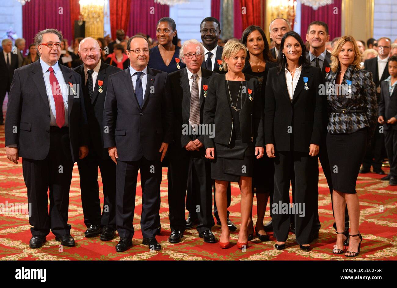 French President Francois Hollande (3rdL) poses with recipients of the Legion of Honor and National Order of Merit insignia during a ceremony to award French sports personalities at the Elysee Palace in Paris, France on October 9, 2013. From left: President of the French Federation of Athletics Bernard Amsalem, former French tennis coach Jean-Claude Perrin, French President Francois Hollande, triple Olympic Champion Marie-Jose Perec, sports journalist Jacques Vendroux, former Olympique de Marseille football club's president Pape Diouf, Olympic Judo champion Cecile Nowak-Grasso, 4x100m World ch Stock Photo