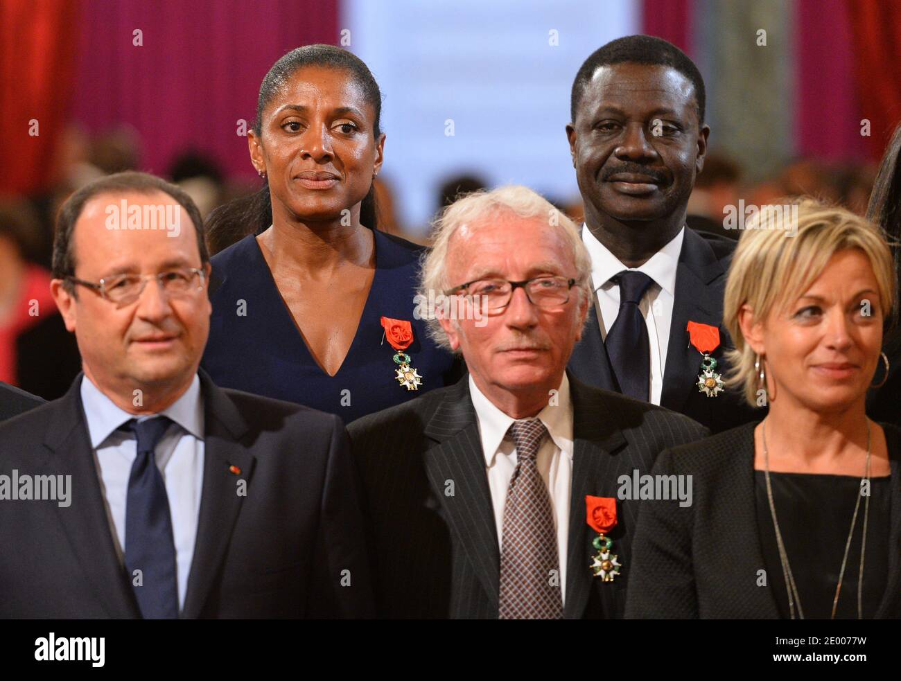 French President Francois Hollande (3rdL) poses with recipients of the Legion of Honor and National Order of Merit insignia during a ceremony to award French sports personalities at the Elysee Palace in Paris, France on October 9, 2013. From left: President of the French Federation of Athletics Bernard Amsalem, former French tennis coach Jean-Claude Perrin, French President Francois Hollande, triple Olympic Champion Marie-Jose Perec, sports journalist Jacques Vendroux, former Olympique de Marseille football club's president Pape Diouf, Olympic Judo champion Cecile Nowak-Grasso, 4x100m World ch Stock Photo