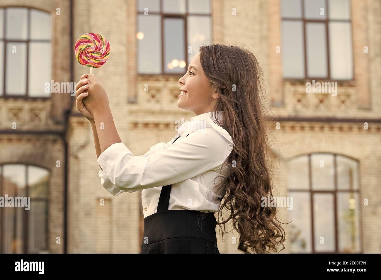 Happy kid with sweet candy. Happy childhood. Kid child holding lollipop