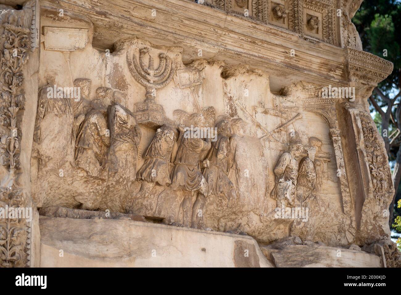 Detail of the Golden Menorah in the Arch of Titus, located on the Via Sacra, just to the south-east of the Roman Forum in Rome, Italy, which was built to commemorate Titus's victory in Judea, depicts a Roman victory procession with soldiers carrying spoils from the Temple, including the Menorah, which were used to fund the construction of the Colosseum, on Wednesday, October 23, 2013. It was constructed c. 82 AD by the Roman Emperor Domitian shortly after the death of his older brother Titus to commemorate Titus' victories, including the Siege of Jerusalem in 70 AD. The Arch is said to have pr Stock Photo
