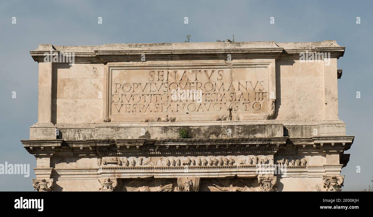 The Arch of Titus, located on the Via Sacra, just to the south-east of the Roman Forum in Rome, Italy, which was built to commemorate Titus's victory in Judea, depicts a Roman victory procession with soldiers carrying spoils from the Temple, including the Menorah, which were used to fund the construction of the Colosseum, on Wednesday, October 23, 2013. The arch was constructed c. 82 AD by the Roman Emperor Domitian shortly after the death of his older brother Titus to commemorate Titus' victories, including the Siege of Jerusalem in 70 AD. The Arch is said to have provided the general model f Stock Photo