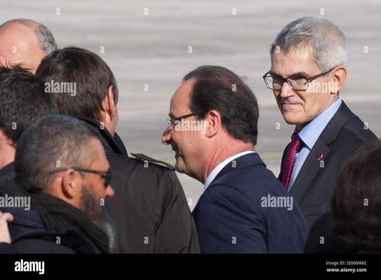 The four French hostages released yesterday in Niger are welcomed by French  President Francois Hollande and Jean-Michel Chereau, Protection Director  Areva, at Villacoublay military airport, near Paris, France on October 30,  2013.