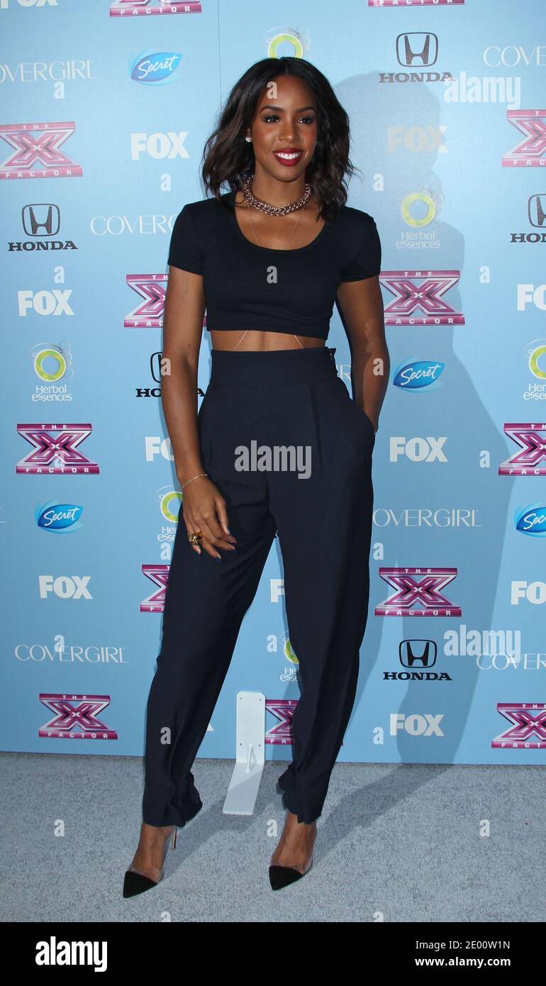 Kelly Rowland celebrating with the Top 12 Finalists of 'The X Factor