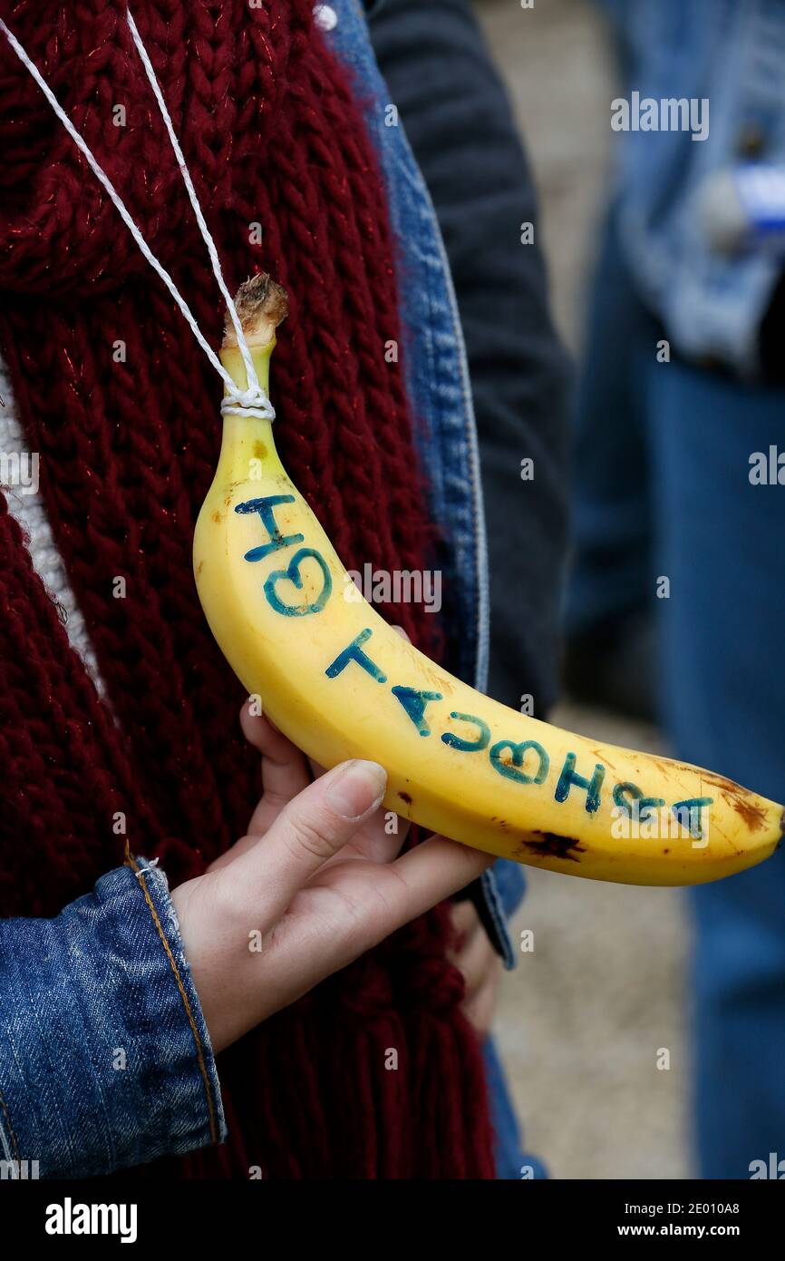 People shows a banana with text reading 'I love Taubira', in reference to the French Justice Minister who was recently confronted with racial slurs, during a demonstration rally by antiracism organisations in Bergerac, southwest France, on November 9, 2013, while the leader of the French far-right Front National (FN) party attended a party meeting in the city. Photo by Patrick Bernard/ABACAPRESS.COM - Bergerac Stock Photo