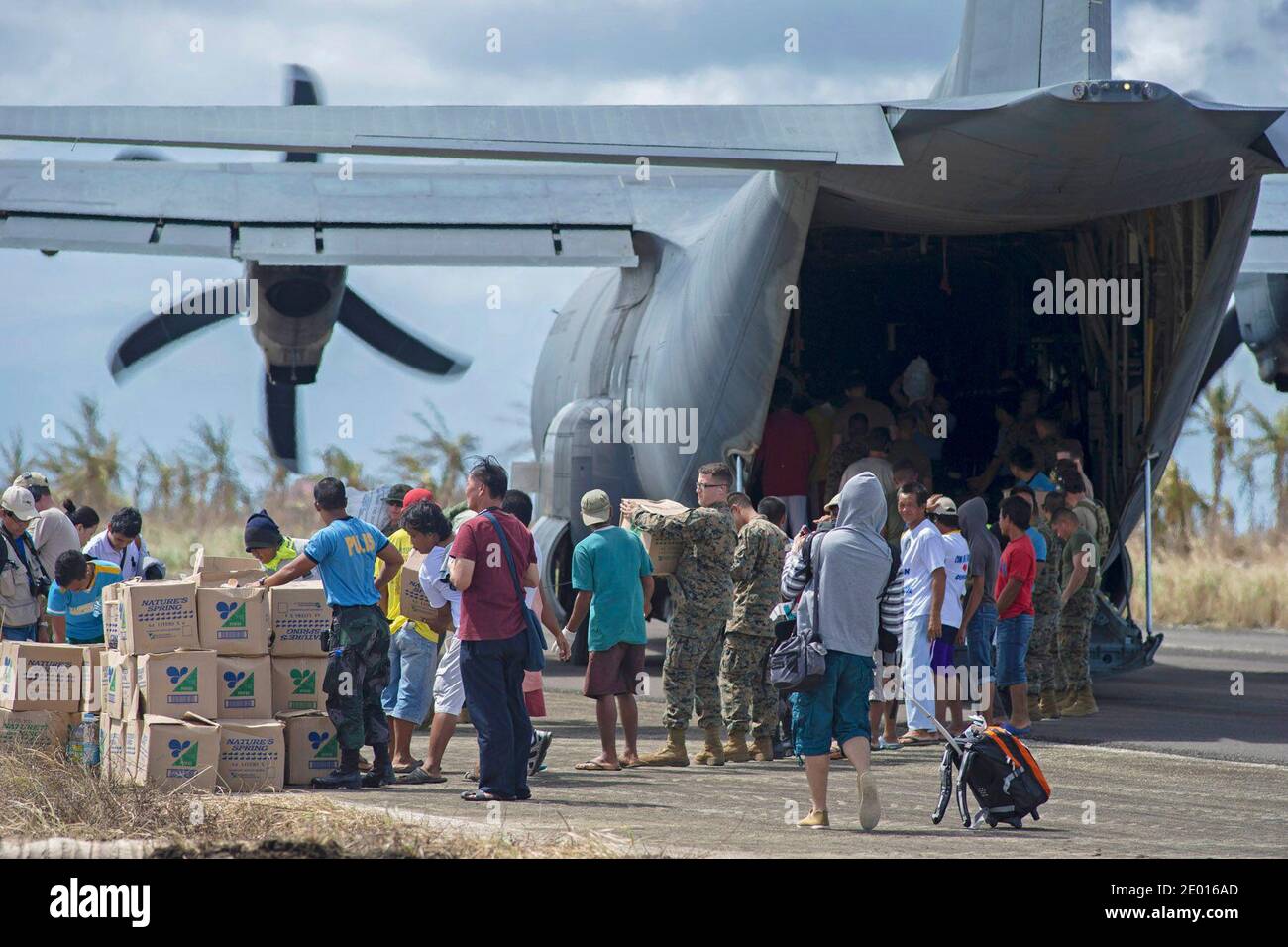 Guiuan, Eastern Samar Province, Republic of the Philippines (Nov. 16, 2013) Sailors from the U.S. Navy's forward-deployed aircraft carrier USS George Washington (CVN 73) alongside Marines and Filipino civilians help unload supplies from an HC-130 Hercules from Marine Wing Support Squadron (MWSS) 172 in support of Operation Damayan. The George Washington Strike Group supports the 3rd Marine Expeditionary Brigade to assist the Philippine government in response to the aftermath of the Super Typhoon Haiyan in the Republic of the Philippines. Photo by US Navy via ABACAPRESS.COM Stock Photo