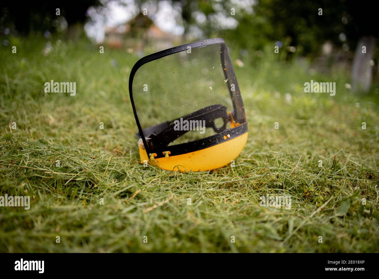 Protective helmet for the mower on cut grass Stock Photo - Alamy
