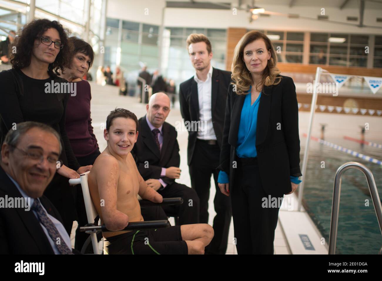 Junior Minister for Disabled People Marie-Arlette Carlotti and companion of France's President Valerie Trierweiler pose with Theo, a 13-year-old 4-limb amputee, next to his mother, four-member amputee swimmer Philippe Croizon, paralympic 100m butterfly - S8 champion Charles Rozoy and Handisports Federation President Gerard Masson on November 27, 2013 in Vichy, central France. Theo is a grant holder of the disabled sports branch of the French Expertise and Performance Ressource Centre (CREPS) of Vichy Auvergne, where he trains in swimming. In early 2013, he competed for the first time in the Fr Stock Photo