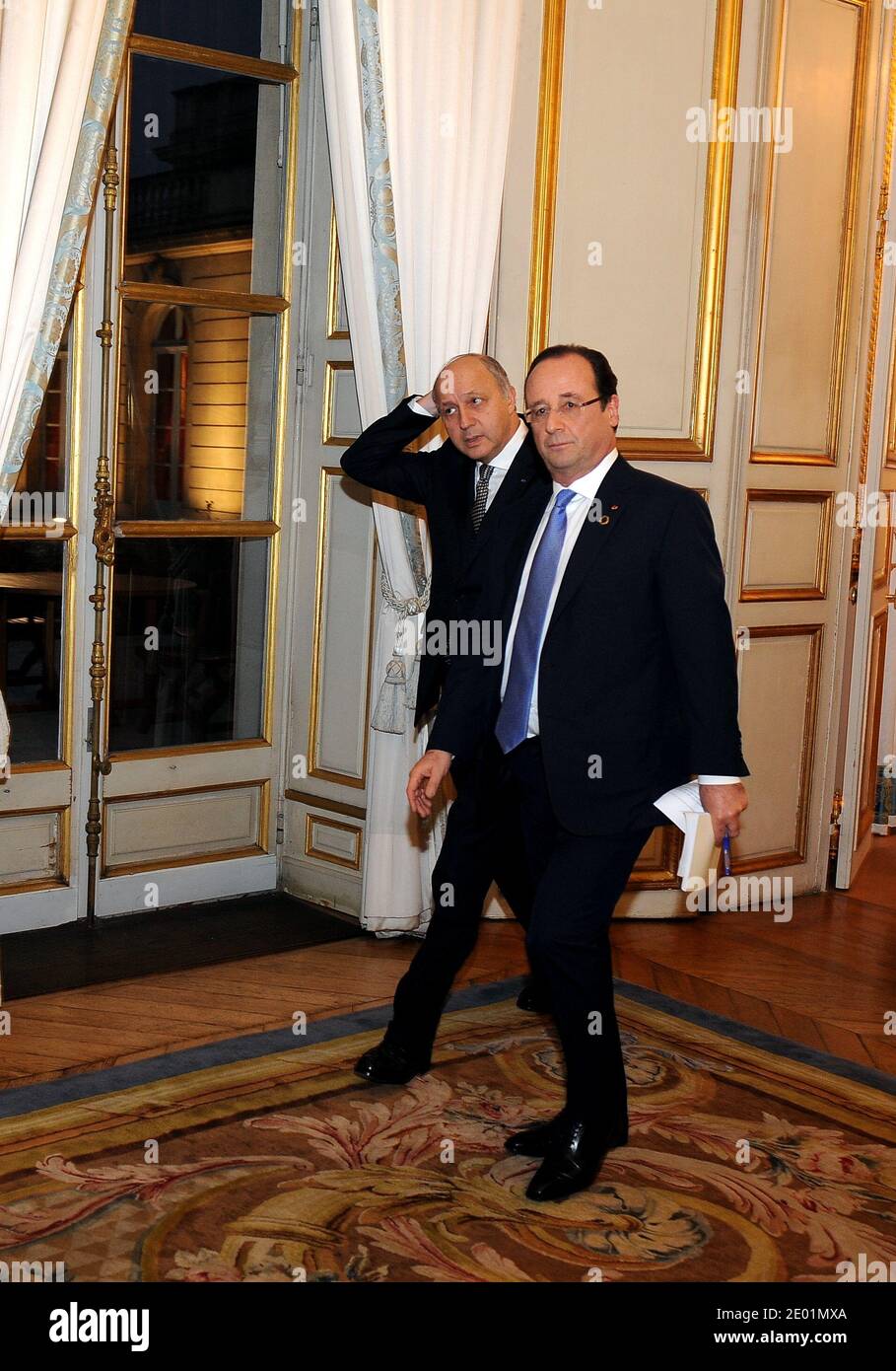 French President Francois Hollande (C) arrives alongside the French Minister of Foreign Affairs Laurent Fabius for a meeting dedicated to the situation in the Central African Republic, as part of a Summit for peace and safety in Africa at the Elysee presidential palace, in Paris, France, on December 7, 2013. Hollande on December 6 told African leaders it is time for their continent to take charge of its own security as a major summit went ahead against the sombre backdrop of the mourning for late former South African president Nelson Mandela. Photo by Mousse/ABACAPRESS.COM Stock Photo