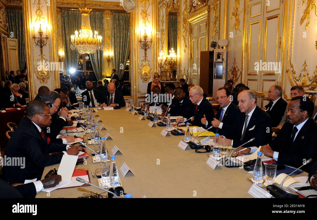 Central African Republic Prime Minister Nicolas Tiangaye (2nd L from bottom) takes part in a meeting about the situation in his country with Gabon's president Ali Bongo Ondimba (1st L), the President of the European Council Herman Van Rompuy (5th R), the French President Francois Hollande (4th R), the French Minister of Foreign Affairs Laurent Fabius (3rd R), and Cameroon's President Paul Biya (2nd R), as part of a Summit for peace and safety in Africa at the Elysee presidential palace, on December 7, 2013, in Paris, France. Hollande on December 6 told African leaders it is time for their cont Stock Photo