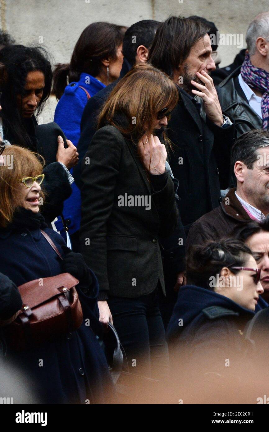 Please hide the children's faces prior to the publication Carla Bruni-Sarkozy attending a tribute mass for Kate Barry held at Saint Roch church in Paris, France on December 19, 2013. Photographer Kate Barry, the daughter of Jane Birkin and John Barry has been found dead on December 11 after falling from the window of her apartment in Paris. She was 46. Photo by ABACAPRESS.COM Stock Photo