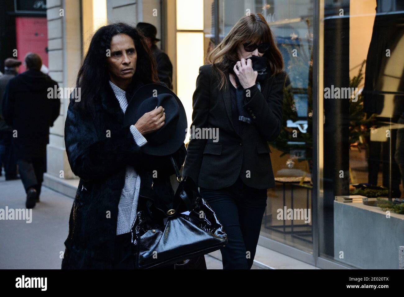 Please hide the children's faces prior to the publication Carla Bruni-Sarkozy and Karine Silla attending a tribute mass for Kate Barry held at Saint Roch church in Paris, France on December 19, 2013. Photographer Kate Barry, the daughter of Jane Birkin and John Barry has been found dead on December 11 after falling from the window of her apartment in Paris. She was 46. Photo by ABACAPRESS.COM Stock Photo