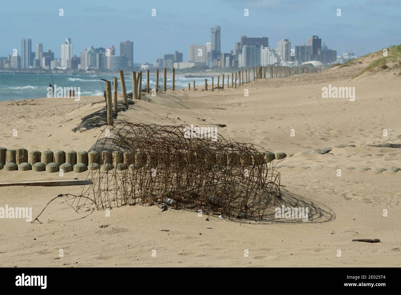 Landscape, urban decay, roll of rusting wire fence, infrastructure neglect, beach management, Durban, KwaZulu-Natal, South Africa, city skyline Stock Photo