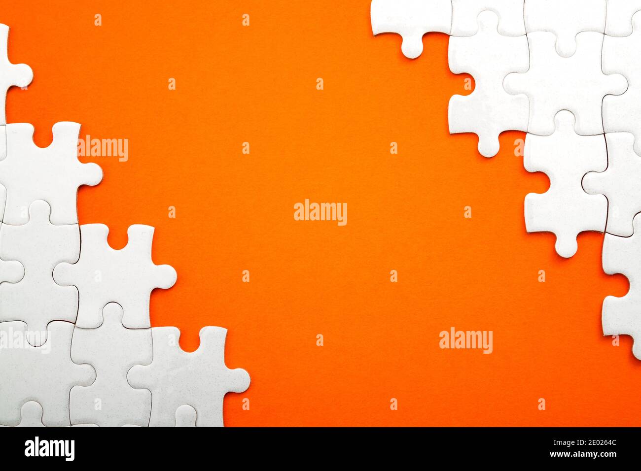 Jigsaw puzzle pieces and business concept with a border made of puzzle  pieces on colorful bright orange background with copy space Stock Photo -  Alamy, image size:1300x956