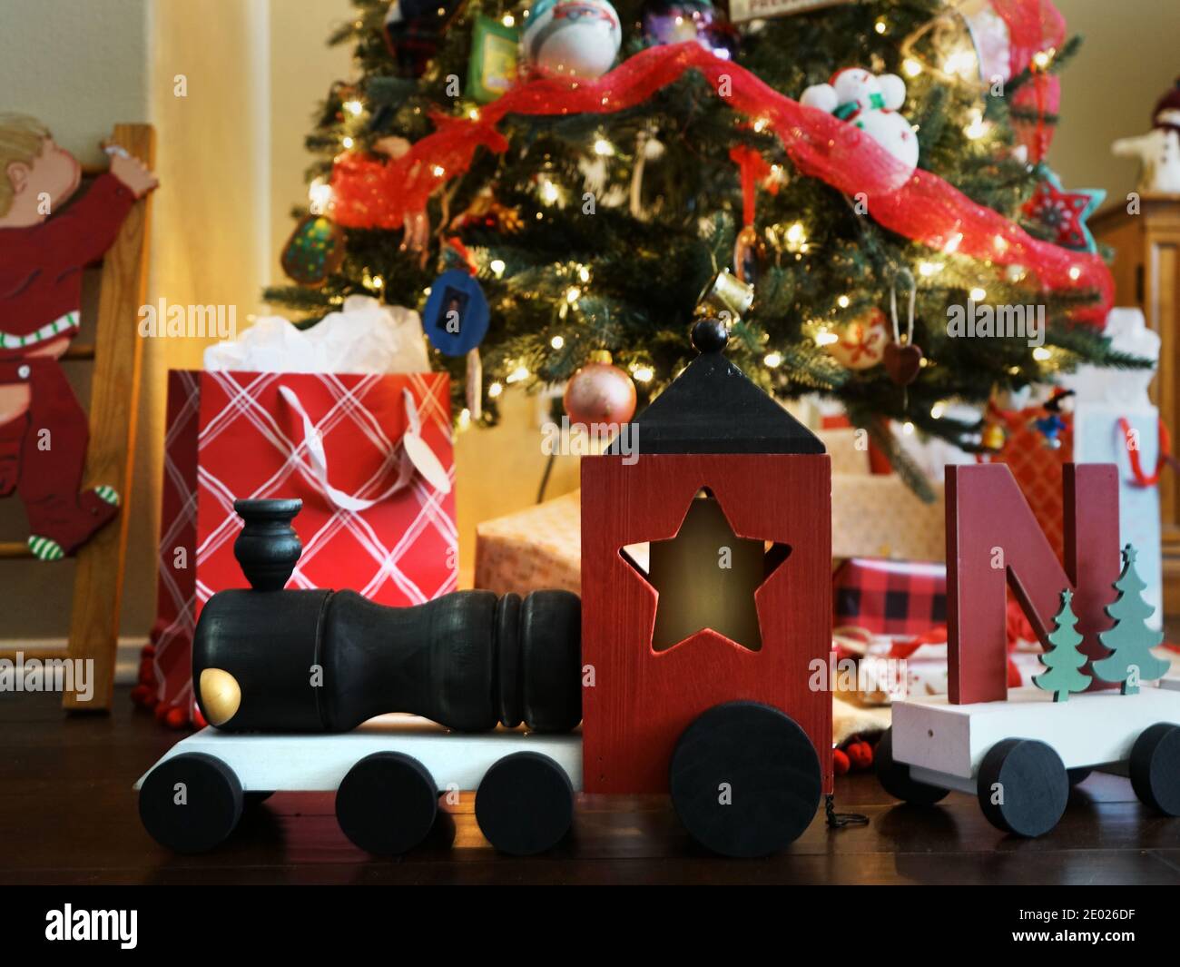 Wooden train and gifts under a Christmas Tree Stock Photo