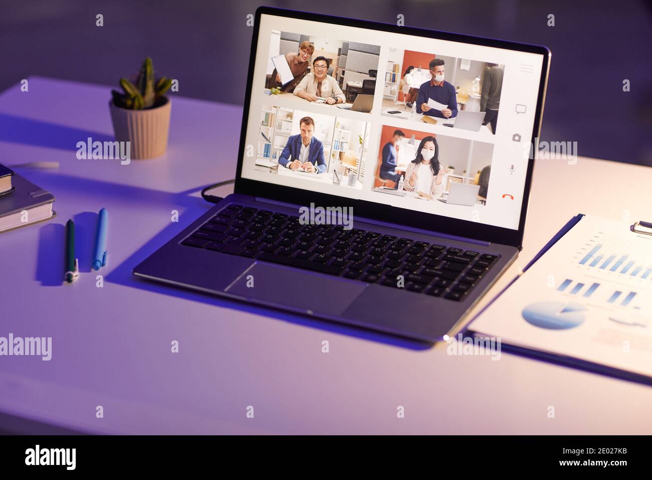 Conceptual shot of online meeting application with four participants on modern laptop screen, copy space Stock Photo