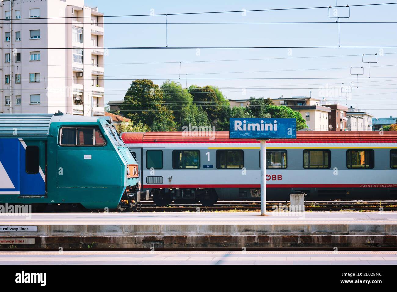 View of regional train waiting at platform at railway station in Rimini