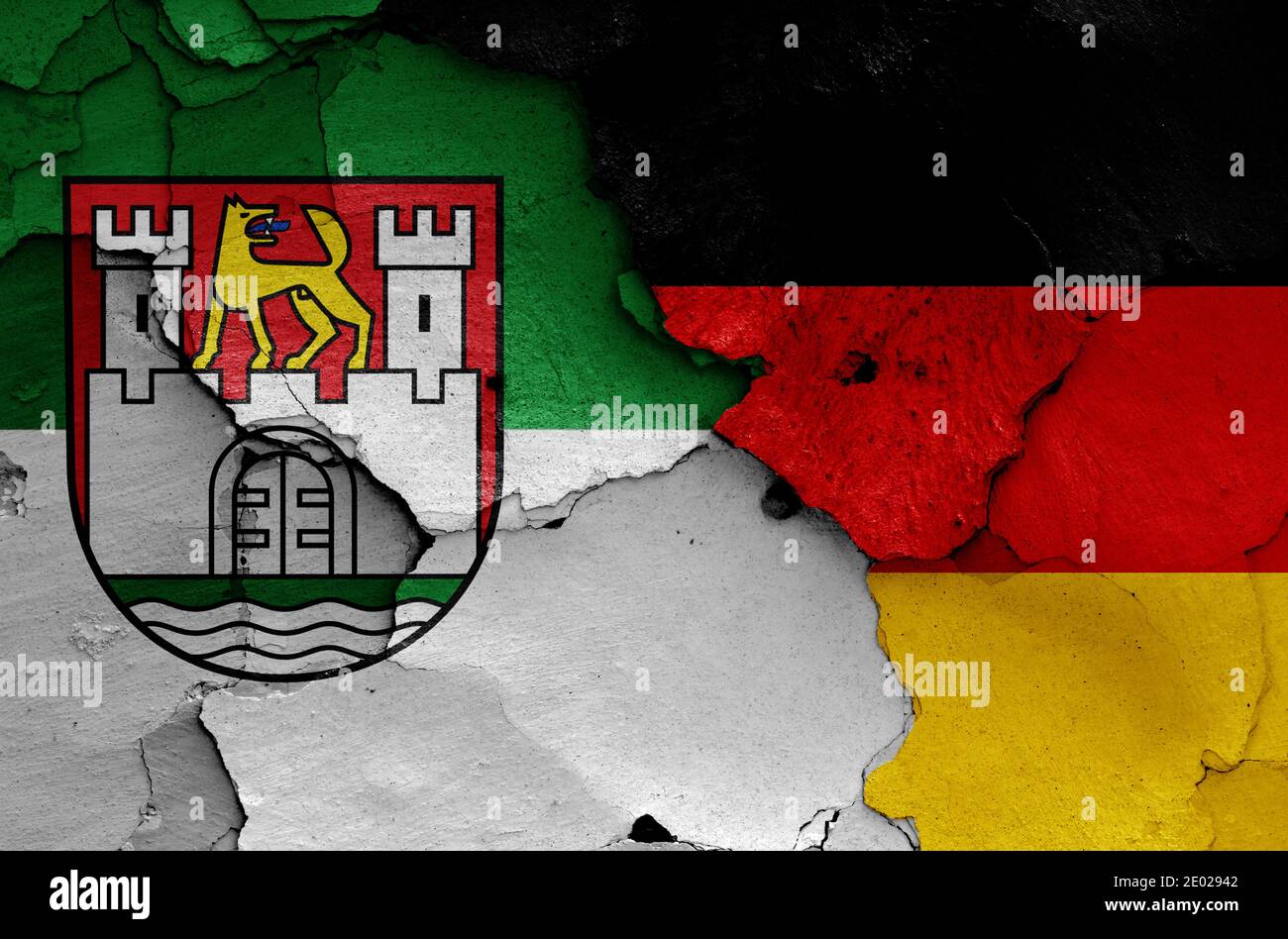 flags of Wolfsburg and Germany painted on cracked wall Stock Photo
