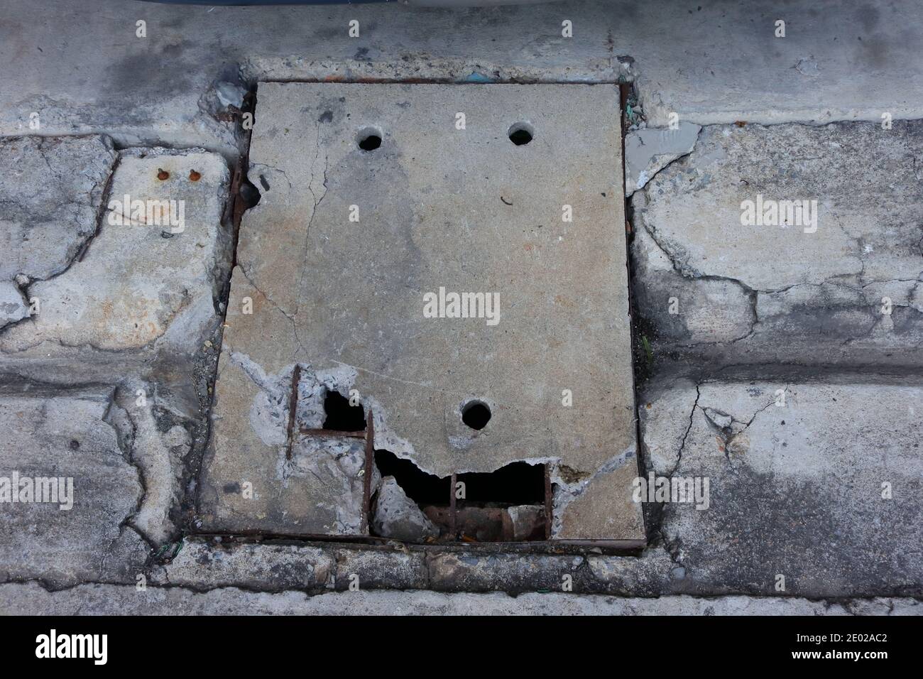 High angle view of broken reinforced concrete drain lid Stock Photo